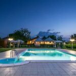Una giornata in piscina a Ferrara all'Agriturismo 3Re Ferrara - Foto dell'esterno al tramonto con piscina illuminata